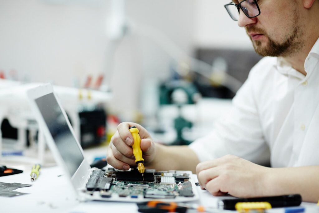 man assembling circuit board laptop